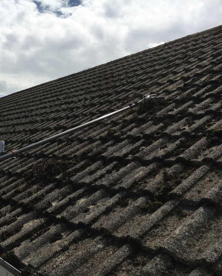 Frome roof cleaning scraping moss from the roof