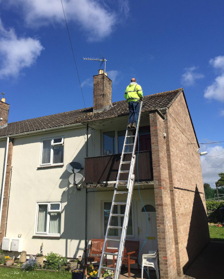 Frome roof cleaning using a pressure washer